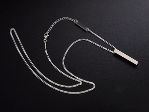 Close-up of silver stainless steel rectangular bar pendant with chain and lobster clasp