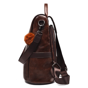 Brown vintage faux leather backpack for women with side zipper and fluffy pompom charm