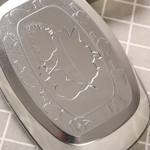 Silver stainless steel tray with embossed rabbit character on brushed metal surface