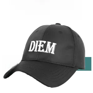 Detail of white DIEM embroidery on a black cotton baseball cap with breathable eyelets
