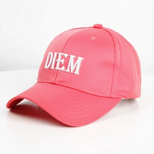 Detailed close-up of a pink cotton baseball cap with white DIEM embroidery and curved brim