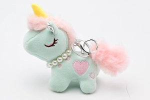 Close-up of mint green plush unicorn keychain with pink fur and pearl necklace detail