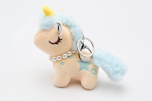 Detail of plush yellow unicorn keychain with blue mane and pearl necklace ornament