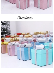 Close-up of matte glitter Christmas gift boxes with festive ribbons in assorted colors