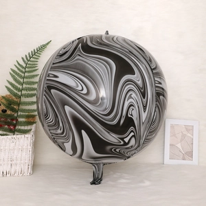 Detailed view of 4D round marble pattern aluminum balloon on a white plush background