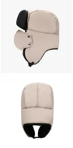 Detail view of winter trapper hat with beige windproof fabric and black warm faux fur lining