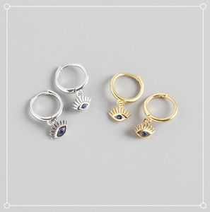 Detailed close-up of S925 sterling silver evil eye hoop earrings in gold and silver
