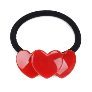 Detailed view of elastic hair tie featuring three glossy red heart-shaped resin charms