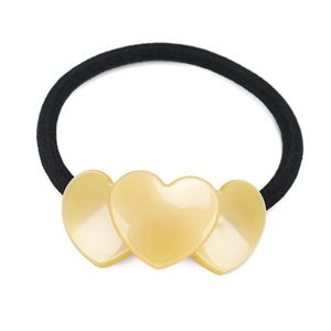 Detailed shot of elastic hair tie featuring three glossy yellow heart-shaped acetate charms