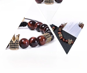 Close-up of 8mm red tiger eye beads and pavé cubic zirconia crown on braided bracelet