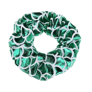 Detailed close-up of green and white fish scale pattern scrunchie with metallic luster