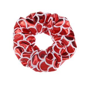 Detailed view of shiny fish scale pattern on a red elastic scrunchie for children