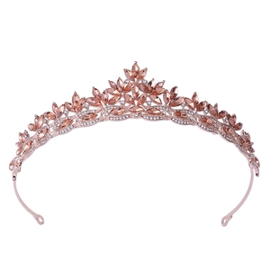 Close-up of rose gold bridal crown with marquise-cut champagne crystals and leaf patterns