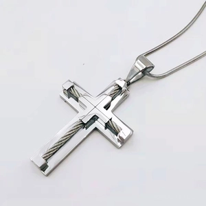 Detailed view of silver stainless steel cross pendant with braided wire inlay on snake chain