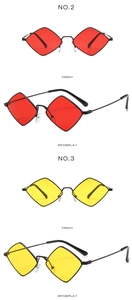 Detail view of stylish diamond-shaped sunglasses with slim black metal frames in red and yellow