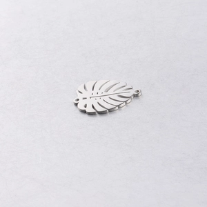 Detailed close-up of a silver stainless steel monstera leaf pendant for DIY jewelry