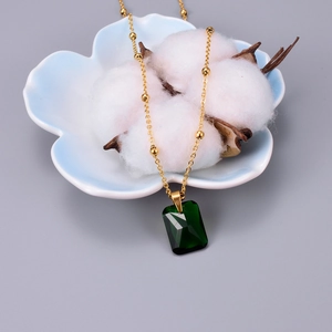 Elegant rose gold necklace featuring a rectangular emerald zircon pendant on a beaded chain