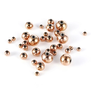 Detailed macro view of rose gold stainless steel hollow beads for DIY jewelry making
