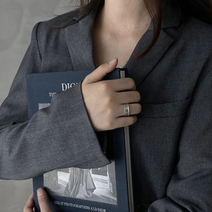 Detail of 925 sterling silver wide band ring with woven texture on model finger