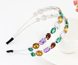 Detail of slim alloy headband with vibrant colorful crystals and rhinestones in silver setting