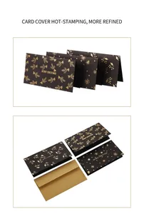 Detail of black Merry Christmas cards with gold foil patterns and matching gold envelopes