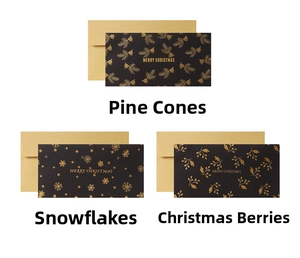 Detailed view of black gold foil Christmas cards featuring pine cones and snowflakes