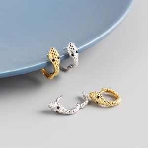 Detailed scale texture and black stone eyes on gold and silver snake hoop earrings
