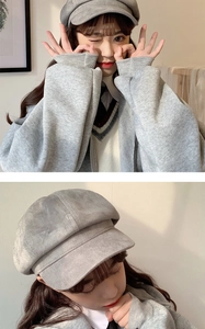 Detail view of a gray wool newsboy cap featuring soft texture and a classic octagonal shape