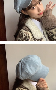Detail of light blue suede newsboy cap featuring a decorative top button for winter