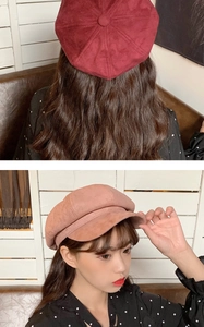 Detail of retro newsboy octagonal hats in burgundy and pink suede fabric on model