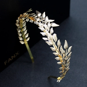 Elegant gold leaf bridal headband with detailed laurel leaves for wedding hair styling