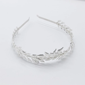 Close-up of silver leaf crown headband with detailed metal branch design for weddings