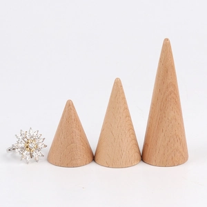 Set of conical solid wood ring display stands with natural beech wood grain on white background