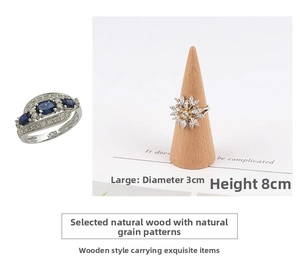 Detail view of 3cm diameter beech wood cone ring stand displaying various gemstone rings