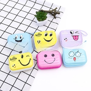 Detailed view of colorful cartoon square tinplate coin purses with lanyards and smile design