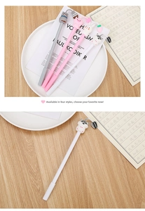Close-up of cute cartoon animal gel pens with 3D soft silicone charms on a wooden desk