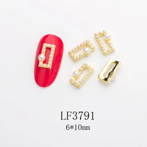 Macro view of gold rectangular frame nail charms with pearls and size details 6x10mm