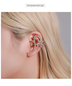 Detail of crystal butterfly floral ear cuff with gold metal and sparkling rhinestones