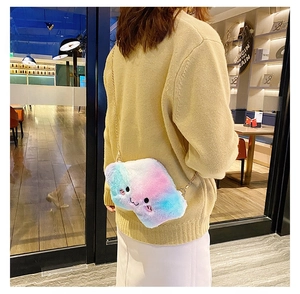 Rainbow gradient plush cloud bag with embroidery and gold chain worn by a model