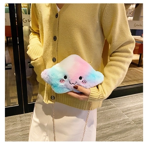 Rainbow gradient plush cloud crossbody bag with golden chain shown on a model