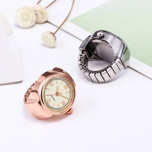 Detail of rose gold and gunmetal ring watches with Roman numerals and elastic band