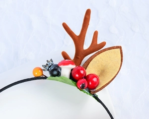 Detailed view of Christmas headband with plush brown antlers, red berries and mushrooms
