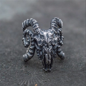 Macro shot of silver gothic ram skull ring with detailed horn texture and antique finish