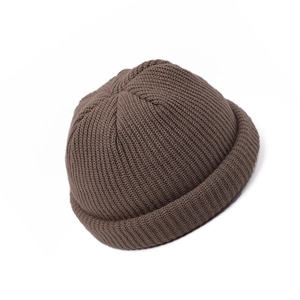 Detail view of the retro dark brown knit skull cap showing thick woven texture and dome shape