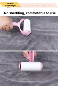 Pink manual lint roller with white adhesive paper cleaning hair on grey fabric