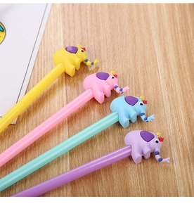 Detailed view of four colorful cartoon elephant pens arranged on a light wooden surface