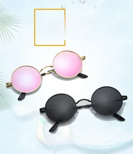Close-up of retro round polarized sunglasses with gold and black metal frames
