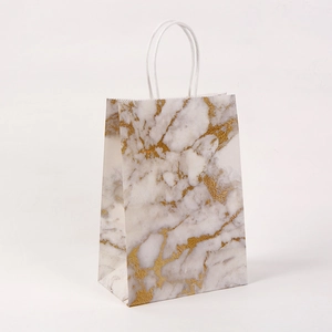 Detail of marble pattern paper gift bag with gold veins and sturdy white paper handles