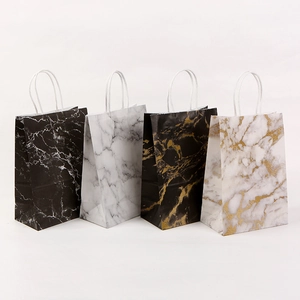 Marble pattern paper shopping bags in black, white, and gold with white rope handles