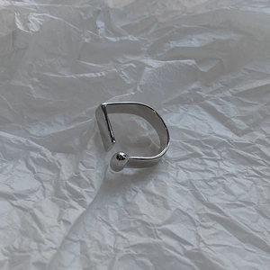 Macro shot of silver D-shape geometric open ring with rectangle end and small round bead